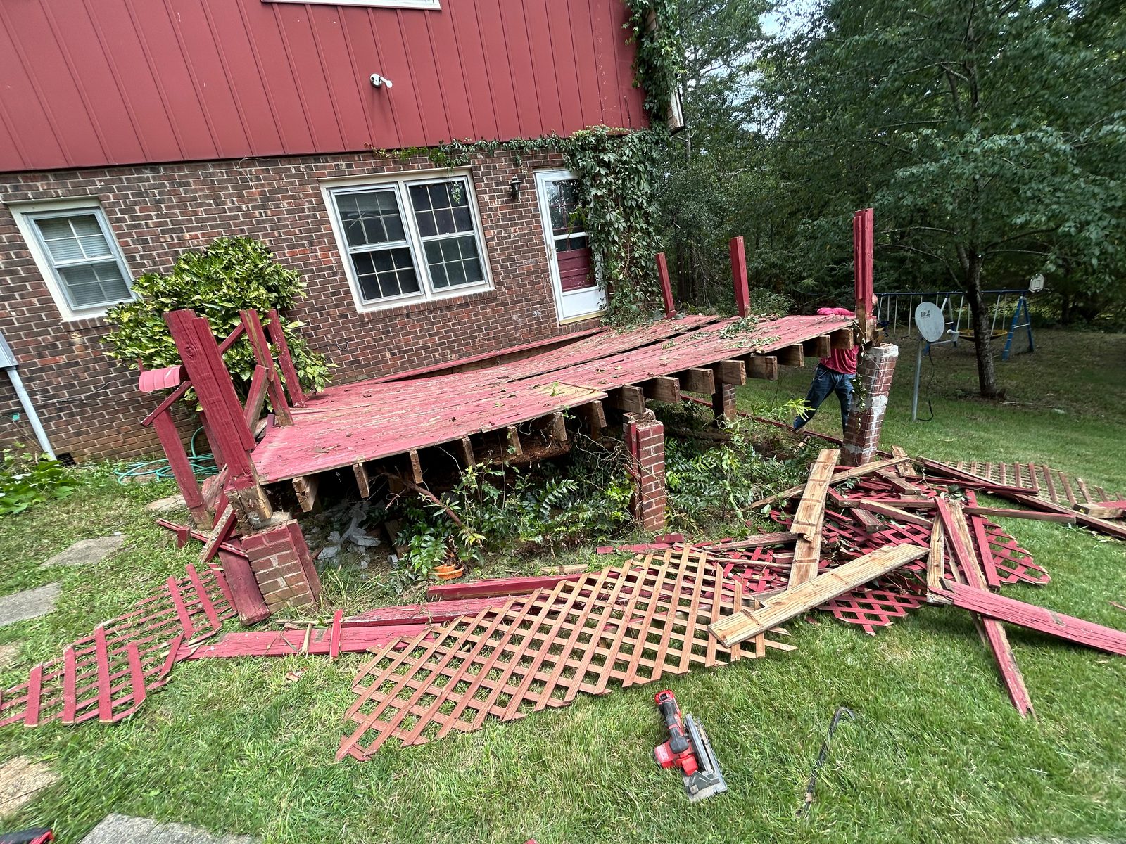 Completed deck rebuild behind a brick home