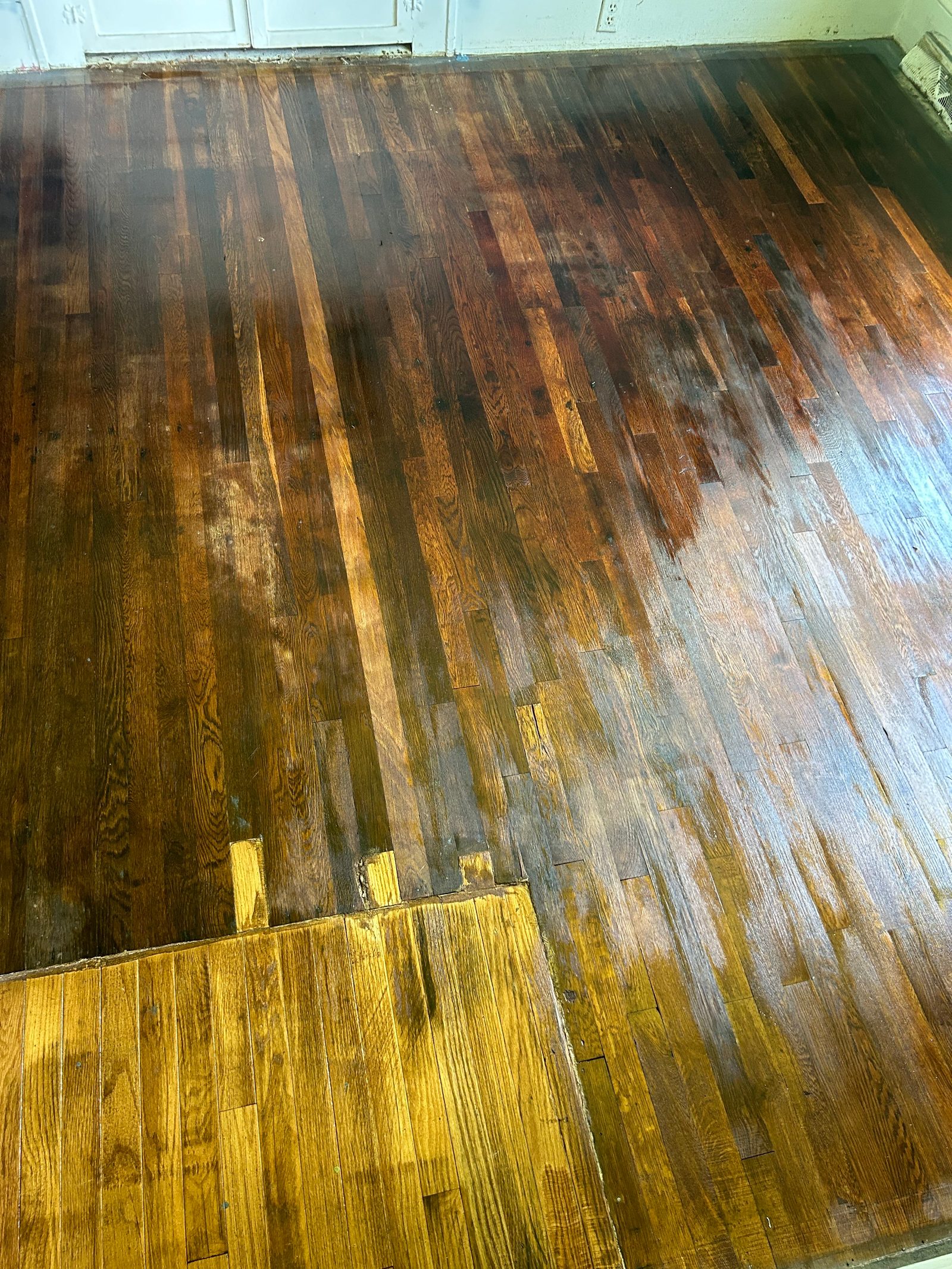 Hardwood floor refinishing project in progress
